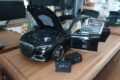 Mercedes-Maybach S-Class 1:18 model in Obsidian Black with doors and hood open, next to two Maybach luggage bags