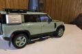 Land Rover Defender 110 75th Limited Edition 1:18 model in pale green, rear three-quarter view with spare wheel and roof rack