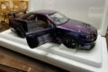 Nissan Skyline GT-R R34 Z-Tune 1:18 model in Midnight Purple with the driver door open, in its foam packaging