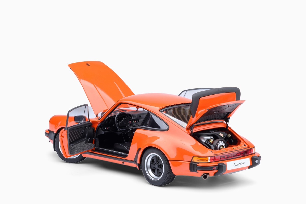 AUTOart 1/18 Porsche 911 (930) Turbo 3.0 in Continental Orange, three-quarter view with doors and lids open