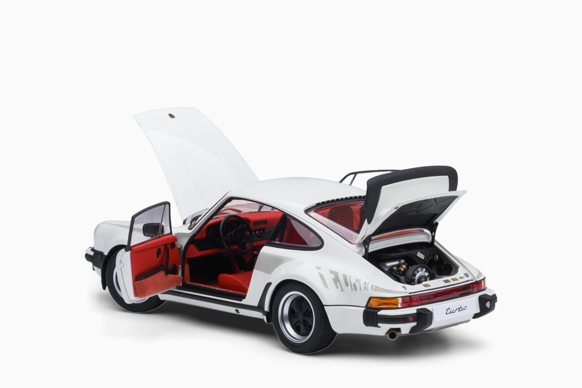 AUTOart 1/18 Porsche 911 (930) Turbo 3.0 in Grand Prix White w/Turbo Stripes, three-quarter view with doors and lids open